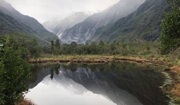 Mountain valley reflected in a still pond.