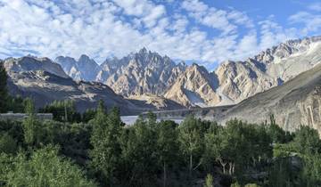 Mountain peaks with vibrant greenery and clear blue skies.