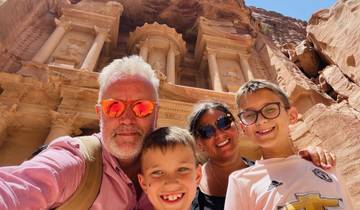 A family taking a selfie in front of Petra.