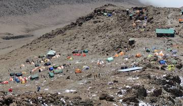 A camping site with colorful tents set up on rocky terrain.