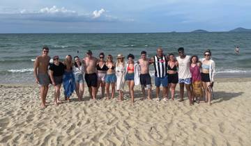 A group enjoying the beach with ocean in view.