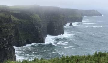 Dramatic view of the Cliffs of Moher and crashing waves below.