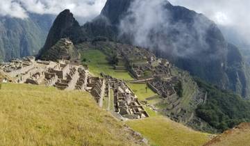 Iconic Machu Picchu ruins surrounded by mist-covered mountains.