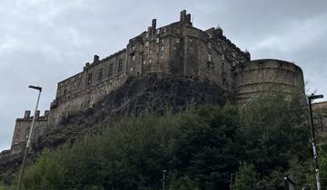Imposing stone castle situated on a rocky hill.