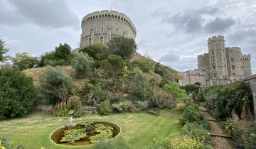 Castle with towers and surrounding gardens.