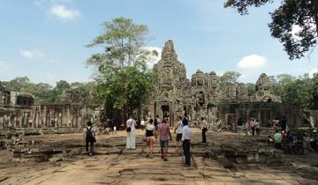 People exploring the ruins of an ancient temple complex.