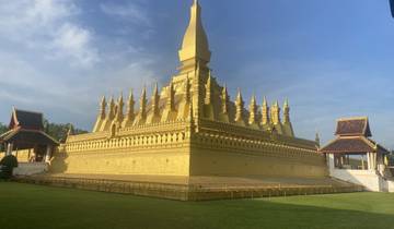 Golden temple complex under a blue sky