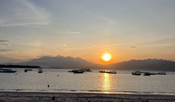 Sunset over the ocean with boats