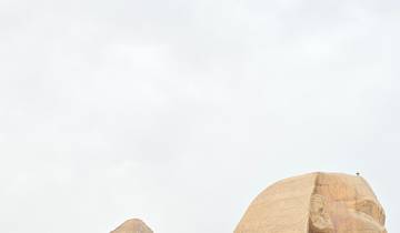 Sphinx and the Great Pyramid under a bright sky.