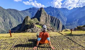 Scenic view of Machu Picchu with a person enjoying the view.