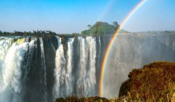 Victoria Falls with a double rainbow above the waterfall.