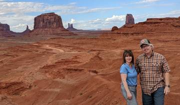 A couple posing with the formations of Monument Valley in the background.