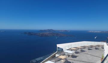 Scenic view of the sea with islands and boats, as seen from a balcony.