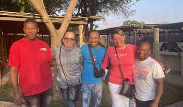 Group of people posing outdoors.