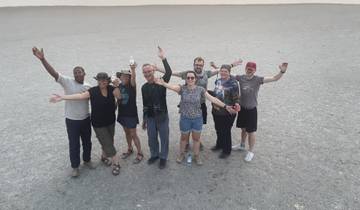 Group photo of people in a desert landscape.