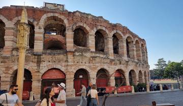 Ancient coliseum with tourists around.