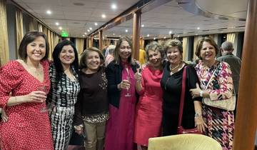 Group of women posing on a cruise with drinks