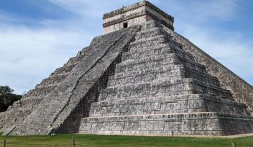 Famous pyramid at Chichen Itza under a clear blue sky.
