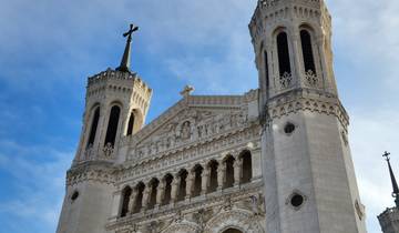 The Basilica of Notre-Dame de Fourvière against a blue sky.