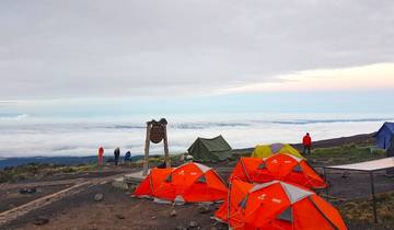 Climbers at a mountain camp above the clouds.