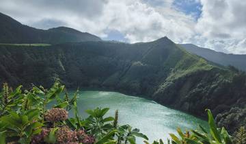 Lush green hills surrounding an emerald lake.