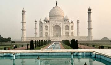 The Taj Mahal with a garden and reflection pool in the foreground.