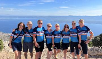 Group of cyclists with a scenic view in the background.