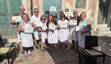 Group of people showing off certificates, likely after a cooking class.