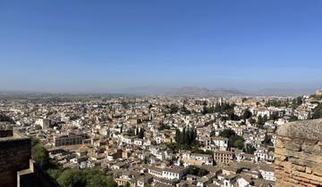 Panoramic view of a cityscape with mountains in the background.