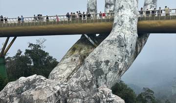 Golden Bridge with tourists, unique hand-shaped supports.