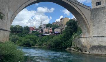 Stari Most bridge with a town view in the background.