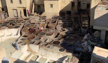 Workers at a traditional tannery with multiple dye pits.