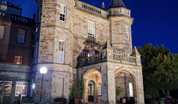 Illuminated stone building at night.