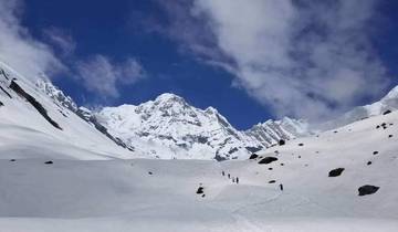 Snow-covered mountain range under a clear blue sky.