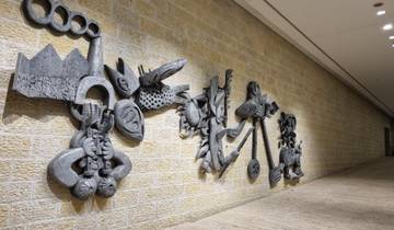 Art sculpture on a stone wall in an interior setting