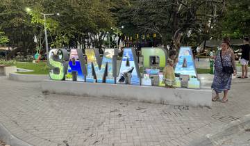 Decorative Samara sign with people interacting around it.