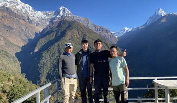 Group of people posing with mountains in background.