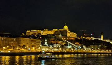 Night view of a lit cityscape with river.