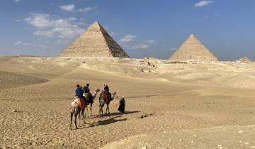 Camel ride near the pyramids with clear sky