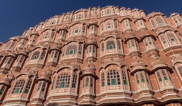 Facade of a pink historical building with many windows.