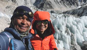 Two climbers posing in a snowy mountain setting.