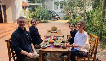 A family enjoying a meal outdoors in a courtyard.