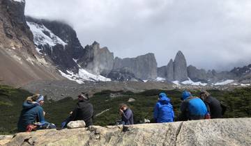 Group of people sitting and admiring the mountains in Patagonia.