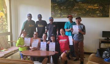 Group of hikers holding certificates.