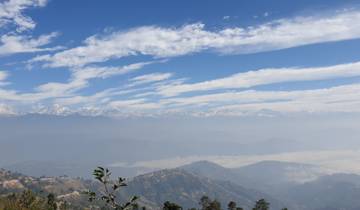 Expansive mountain range under a blue sky.