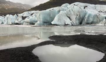 Majestic glacier with blue ice and surrounding water.