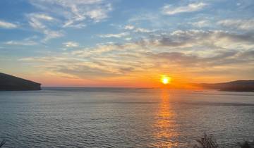 Sunset over the sea with a dramatic sky view.