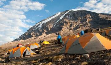 Camping site with tents at the mountain base.