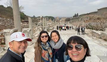 Group of people sightseeing at ancient ruins.