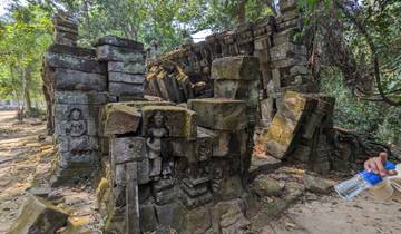 Stone carvings and ruins in a forest setting.